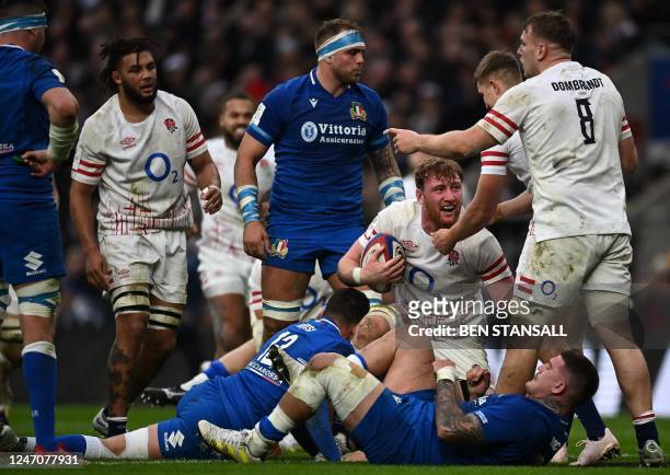 England's flanker Ollie Chessum holds the ball as he celebrates after scoring the team's second try during the Six Nations international rugby union...