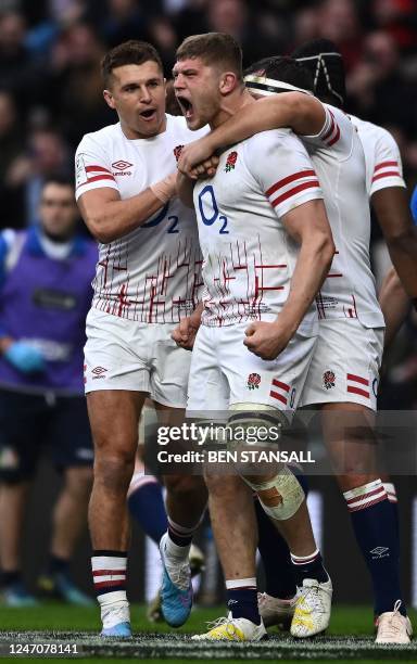 England's flanker Jack Willis celebrates after scoring the team's first try during the Six Nations international rugby union match between England...