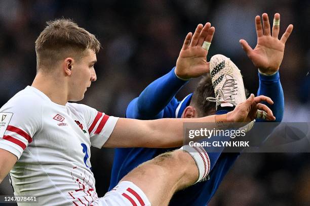 Italy's lock Federico Ruzza charges down a kick by England's scrum-half Jack van Poortlviet during the Six Nations international rugby union match...