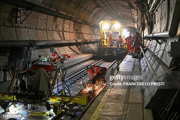 Workers replace rails in the Channel Tunnel during a "sleepless night" reserved for maintenance, on February 12, 2023. - The Channel Tunnel opened in...