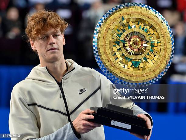 Italy's Jannik Sinner poses with the winner's trophy after winning the Open Sud de France ATP World Tour tennis tournament final against USA's Maxime...