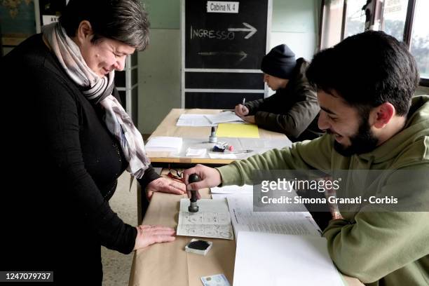 Teller stamps a voter's electoral card in a polling station for the renewal of the office of President of the Region and of the Regional Council in...