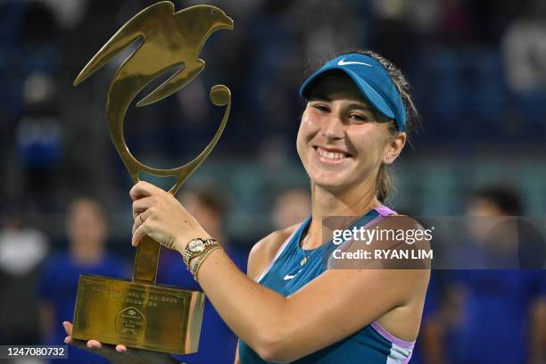 Belinda Bencic of Switzerland poses with the trophy during the podium ceremony after winning the Women's Singles final match of the Mubadala Abu...