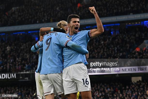 Manchester City's Spanish midfielder Rodri celebrates with Manchester City's Norwegian striker Erling Haaland after City score their second goal...