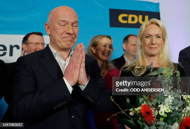 Christian Democratic Union party's top candidate Kai Wegner celebrates next to his partner Katleen Kantar after the first exit poll results for the...