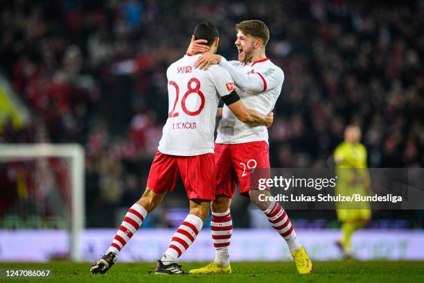 Scorer Ellyes Skhiri of Köln celebrates his teams third goal with Jan Thielmann of Köln during the Bundesliga match between 1. FC Köln and Eintracht...