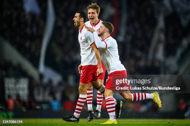 Scorer Ellyes Skhiri of Köln celebrates his teams third goal with Timo Hübers and Jan Thielmann of Köln during the Bundesliga match between 1. FC...