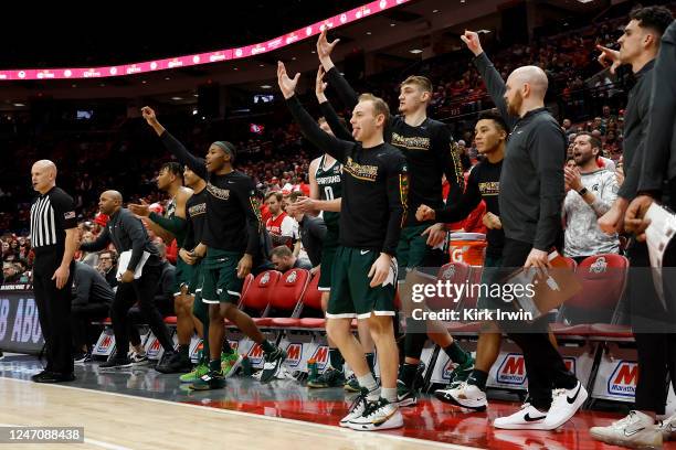 Steven Izzo of the Michigan State Spartans and his teammates react after a made three-point shot during the second half of the game against the Ohio...