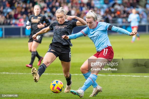 Lauren Hemp of Manchester City tackled by Leah Williamson during the Barclays FA Women's Super League match between Manchester City and Arsenal at...