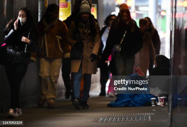 Person begging in the street of the city center of Dublin, Ireland, on February 12, 2023.