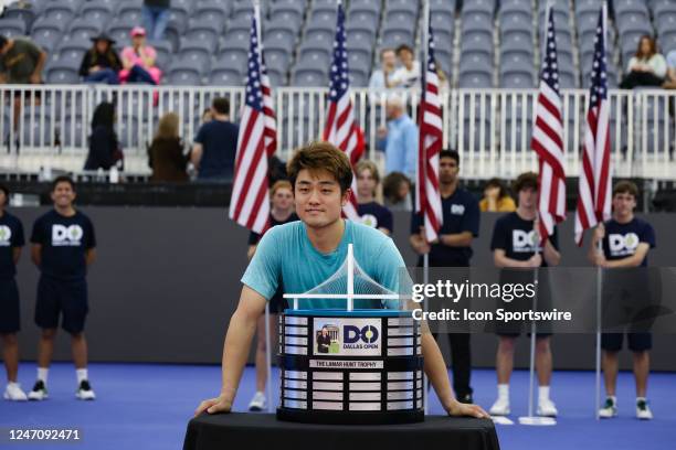 Yibing Wu poses with the Lamar Hunt Trophy after winning the Dallas Open on February 12, 2023 at the Styslinger/Altec Tennis Complex in Dallas, TX.