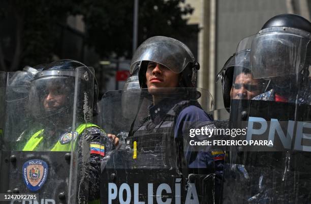 Riot police stand guard during a rally against Venezuelan President Nicolas Maduro on International Youth Day in Caracas, on February 12, 2023.