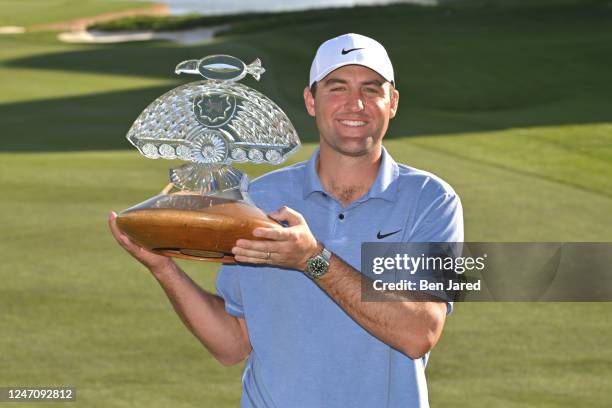 Scottie Scheffler holds the trophy on the 18th green after the final round of the WM Phoenix Open at TPC Scottsdale on February 12, 2023 in...