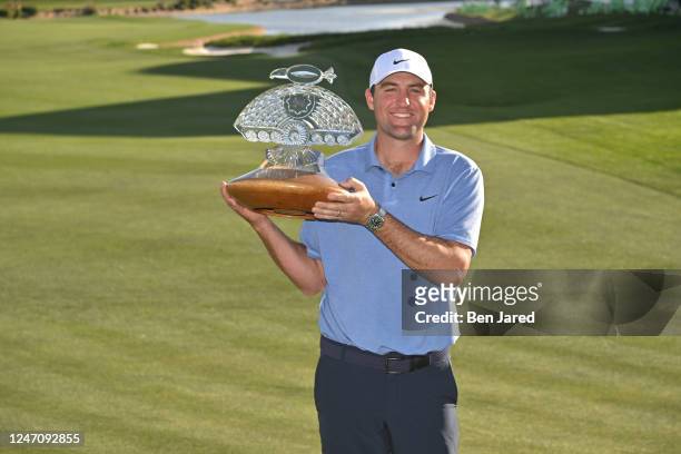 Scottie Scheffler holds the trophy on the 18th green after the final round of the WM Phoenix Open at TPC Scottsdale on February 12, 2023 in...