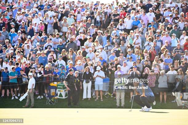 Scottie Scheffler reads the 18th green during the final round of the WM Phoenix Open at TPC Scottsdale on February 12, 2023 in Scottsdale, Arizona.