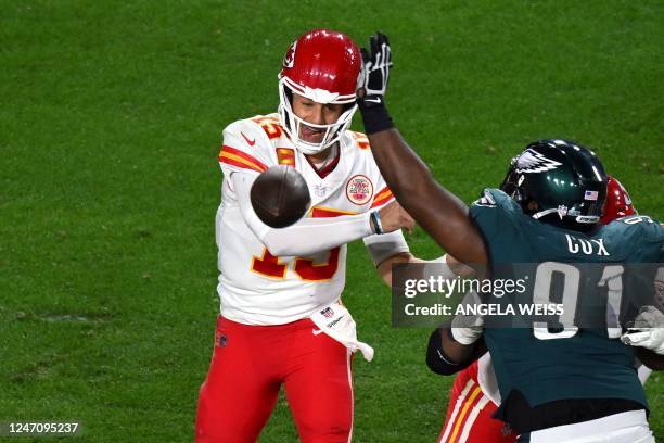 Philadelphia Eagles' defensive tackle Fletcher Cox attempts to block Kansas City Chiefs' quarterback Patrick Mahomes' throw during Super Bowl LVII...