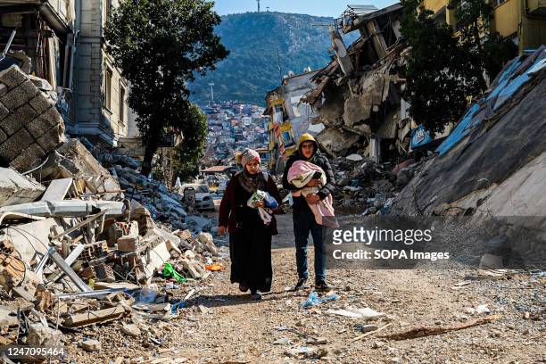Woman and a young man walk through the ruins of the earthquake. Turkey and Syria have experienced the most severe earthquakes to hit the region in...