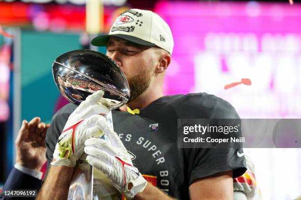 Travis Kelce of the Kansas City Chiefs kisses the Lombardi Trophy after Super Bowl LVII against the Philadelphia Eagles at State Farm Stadium on...