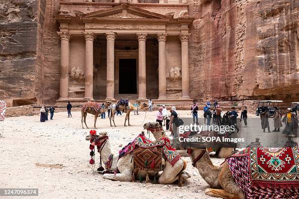 Camels seen in front of The Treasury in Petra, a famous...
