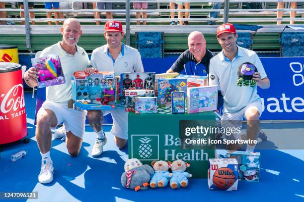 Luke Jensen, Bob Bryan, Murphy Jensen and Mike Bryan pose after the Bryan Brothers defeated the Murphy Brothers in a doubles match at the ATP Delray...