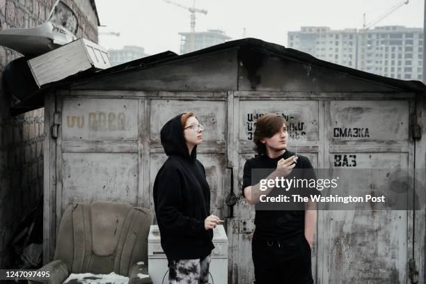 Ekaterina and Yaroslav smoke cigarettes near the shelter provided by the support group Kovcheg , which supports immigrants who left Russian because...
