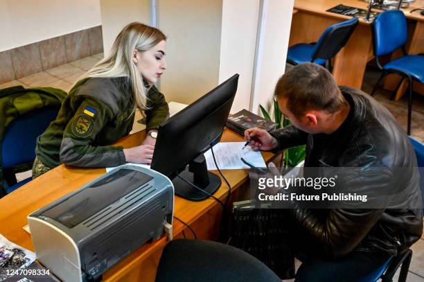 Man fills in the papers at one of the Administrative Service Centres as he wishes to join the Offensive Guard, Zaporizhzhia, southeastern Ukraine....