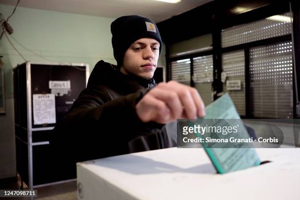 Young man casts his vote in a polling station for the renewal of the office of President of the Region and of the Regional Council in the Lazio...