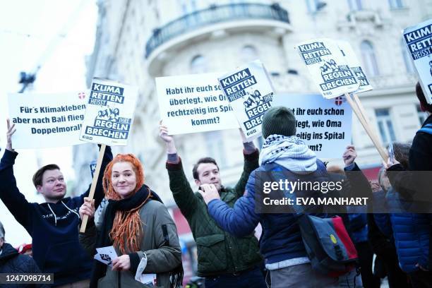 Protesters demonstrate with placards during a blockade in the area of Naschmarkt in Vienna, Austria, on February 13, 2023 as the activists group...