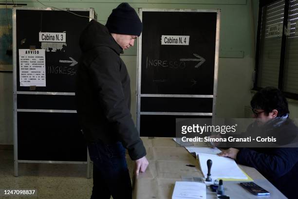 Young man collects his ballot paper before casting his vote in a polling station for the renewal of the office of President of the Region and of the...
