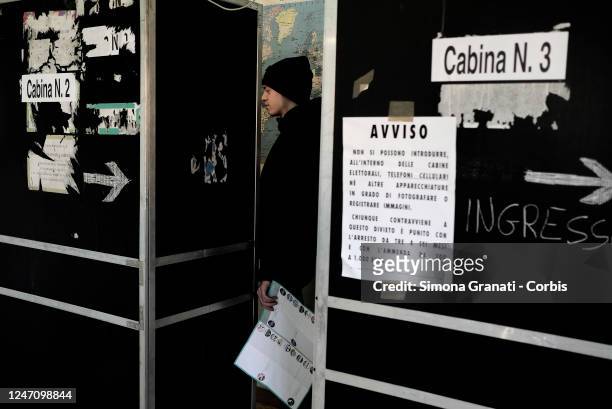 Young man enters a voting booth before casting his vote in a polling station for the renewal of the office of President of the Region and of the...