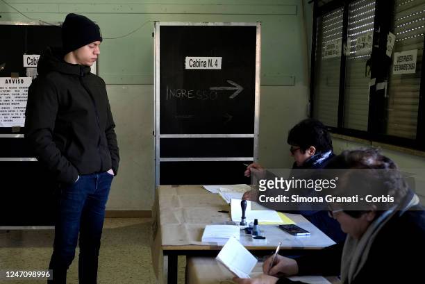 Young man collects his ballot paper before casting his vote in a polling station for the renewal of the office of President of the Region and of the...