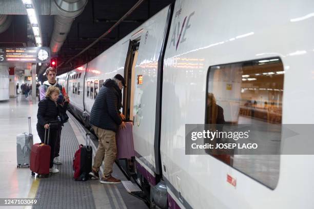 Passengers board a Figueres bound AVE high-speed train at Barcelona-Sants railway station, which route will continue to Lyon on a test trip without...