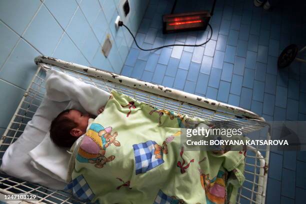 New born baby sleeps next to an electric heater in Sofia's maternity hospital on January 10, 2009. Ukraine will supply natural gas to Bulgaria and...