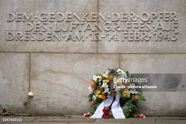 February 2023, Saxony, Dresden: A wreath of flowers lies in Heidefriedhof cemetery in front of the memorial stone for the victims of the bombing raid...
