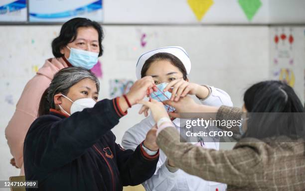 Nurse leads a mentally ill patient to play a game called "flower rope" in Huai 'an, Jiangsu province, China, February 13, 2023. In the psychiatric...