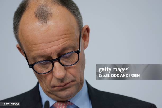 Leader of Germany's conservative Christian Democratic Union party Friedrich Merz looks down during a joint press conference with the party's top...