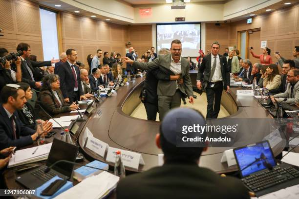 Opposition deputies protest inside the Knesset during a session of the Law Committee as the first stage of controversial judicial reform which...