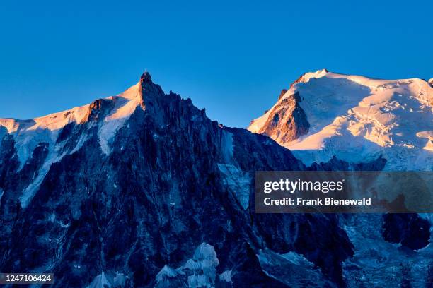 The summits of Aiguille du Midi and Mont Blanc du Tacul, from left, seen from Le Brevent at sunrise.