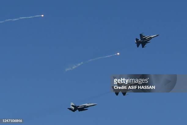 Pakistan's Air Force fighter JF-17 fighter jets fly past during the multinational naval exercise 'AMAN-23' in the Arabian Sea near Pakistan's port...