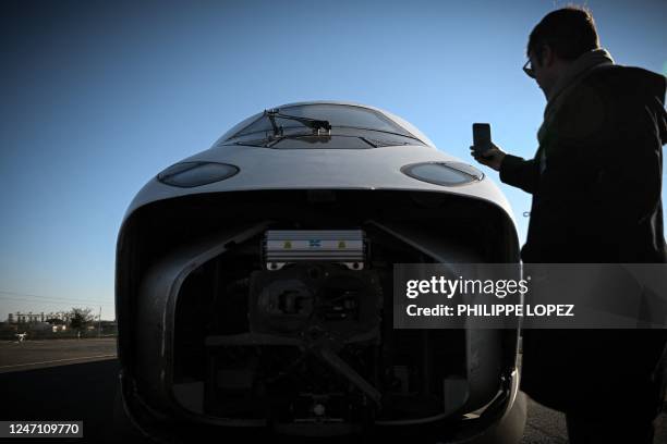 An Alstom employee takes a photograph of the new SNCF TGV "M" next generation high-speed train at the Alstom plant in La Rochelle, western France, on...