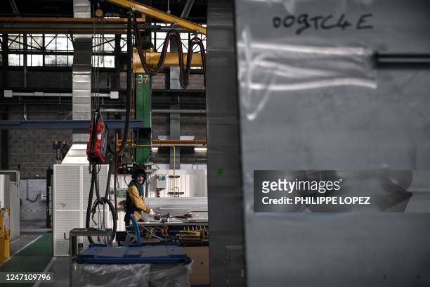 An Alstom employee reacts as he works at the Alstom plant in Aytre near La Rochelle, western France, on February 13, 2023.