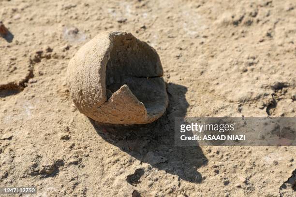 Broken pottery jar is seen at the newly-excavated trench at the site of the ancient city-state of Lagash, in Iraq's al-Shatra district of the...