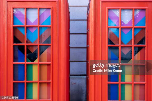 Pride Progress flags decorate the interior of red telephone boxes in Covent Garden on 7th February 2023 in London, United Kingdom. The flag includes...