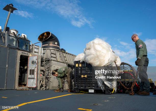 In this U.S. Navy handout, Sailors assigned to Assault Craft Unit 4 prepare material recovered in the Atlantic Ocean from a high-altitude balloon for...