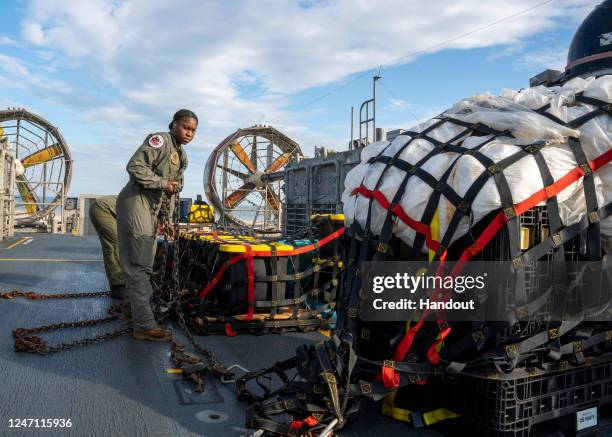 In this U.S. Navy handout, Sailors assigned to Assault Craft Unit 4 prepare material recovered in the Atlantic Ocean from a high-altitude balloon for...