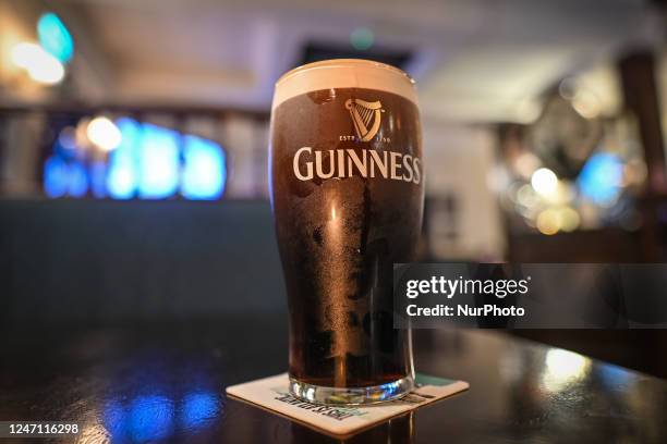 Perfect pint of Guinness on the table inside a pub in Dublin, Ireland, on February 12, 2023.