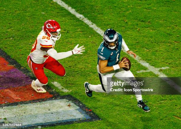 Philadelphia Eagles quarterback Jalen Hurts runs around a defender during Super Bowl LVII between the Philadelphia Eagles and the Kansas City Chiefs...