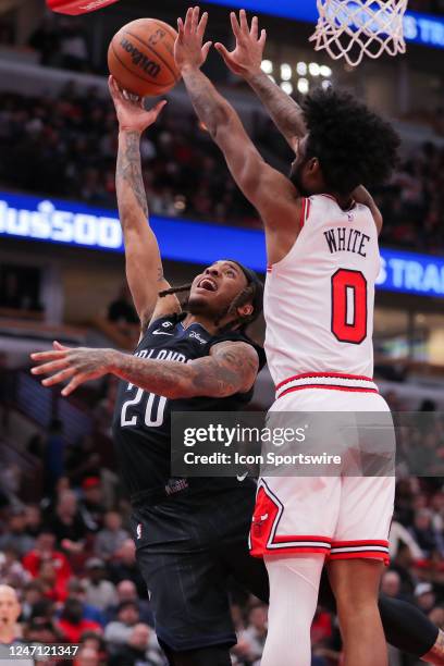 Chicago Bulls Forward Derrick Jones Jr. Defends Orlando Magic Guard Markelle Fultz under the basket during a NBA game between the Orlando Magic and...