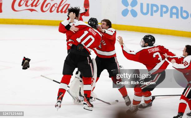 Devon Levi of the Northeastern Huskies celebrates after his game-winning save in the final round of a shootout against the Harvard Crimson during...