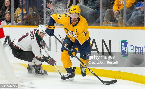 Roman Josi of the Nashville Predators skates against Nick Schmaltz of the Arizona Coyotes during an NHL game at Bridgestone Arena on February 13,...